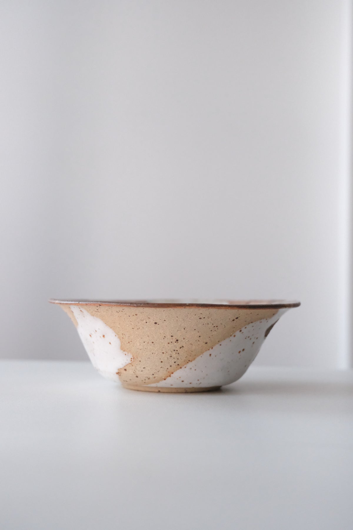 Bowl called “tree, daisy and house hiding from something”