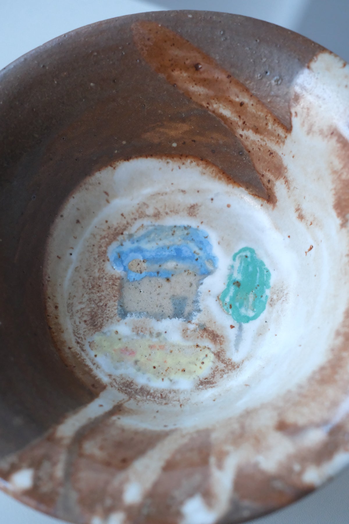 Bowl called “tree, daisy and house hiding from something”