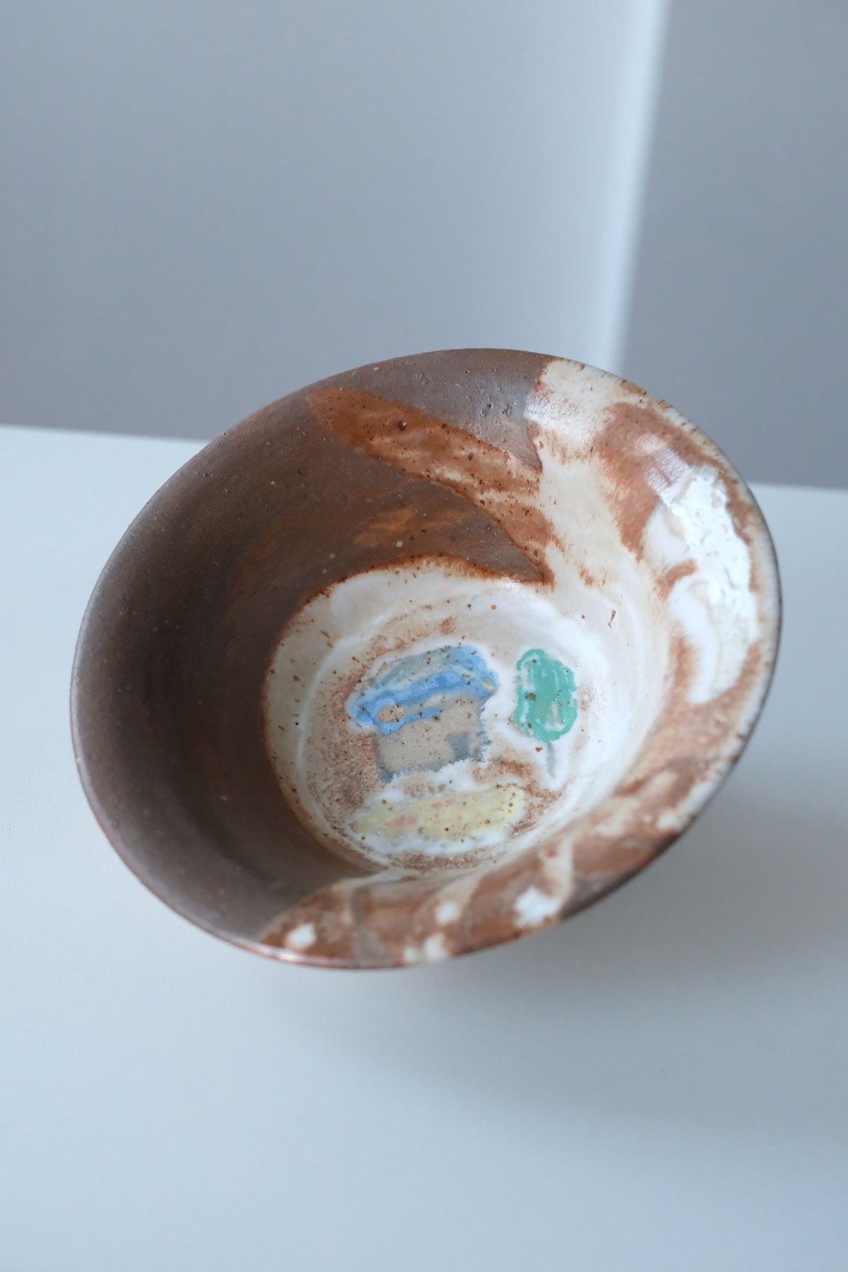 Bowl called “tree, daisy and house hiding from something”