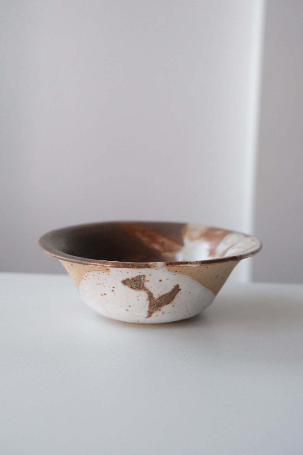 Bowl called “tree, daisy and house hiding from something”