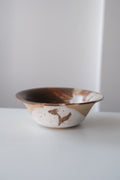 Bowl called “tree, daisy and house hiding from something”